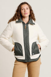 A model wearing the Fortunes Reversible Jacket in colour Multi (Green), from the front, cropped image