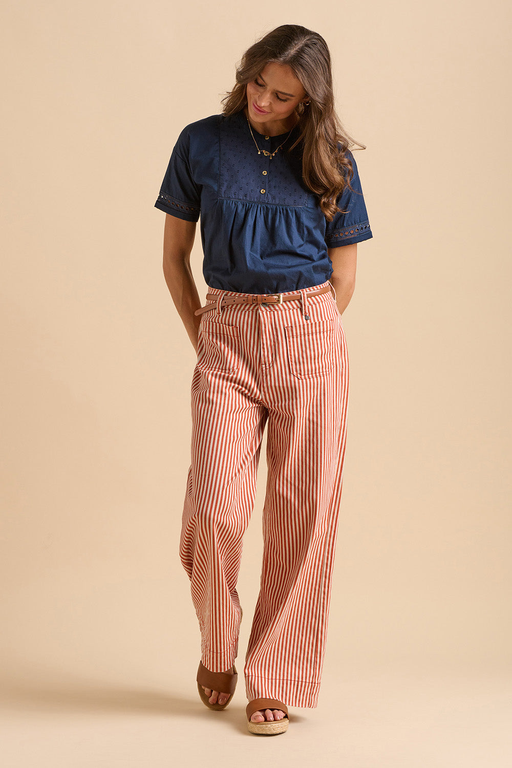 A model wearing the Stripe Straight Leg Jeans in colour Redwhite, from the front, showing the whole outfit