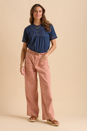 A model wearing the Stripe Straight Leg Jeans in colour Redwhite, from the front, showing the whole outfit
