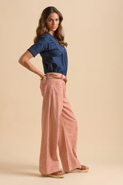 A model wearing the Stripe Straight Leg Jeans in colour Redwhite, from the front, showing the whole outfit