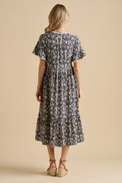 A model wearing the Arrows Cotton Midi Dress in colour Navy (Blue), from the back