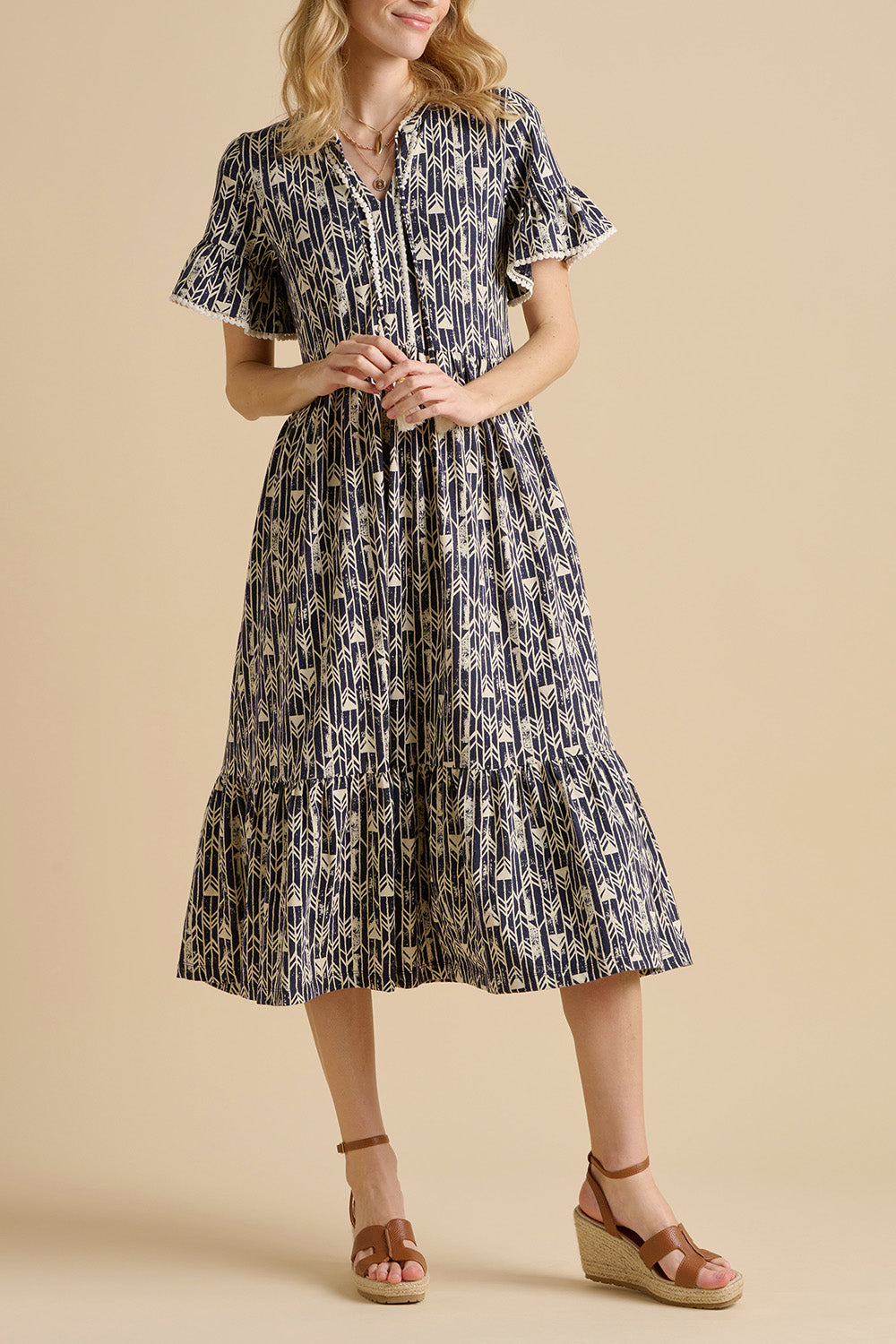 A model wearing the Arrows Cotton Midi Dress in colour Navy (Blue), from the front, cropped image