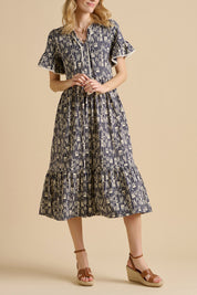 A model wearing the Arrows Cotton Midi Dress in colour Navy (Blue), from the front, cropped image