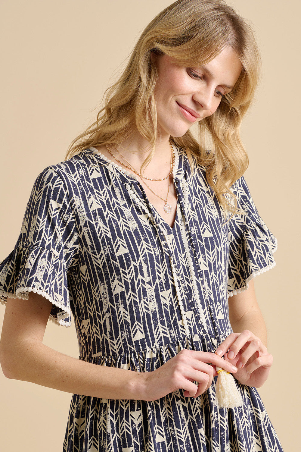 A model wearing the Arrows Cotton Midi Dress in colour Navy (Blue), from the front, cropped image