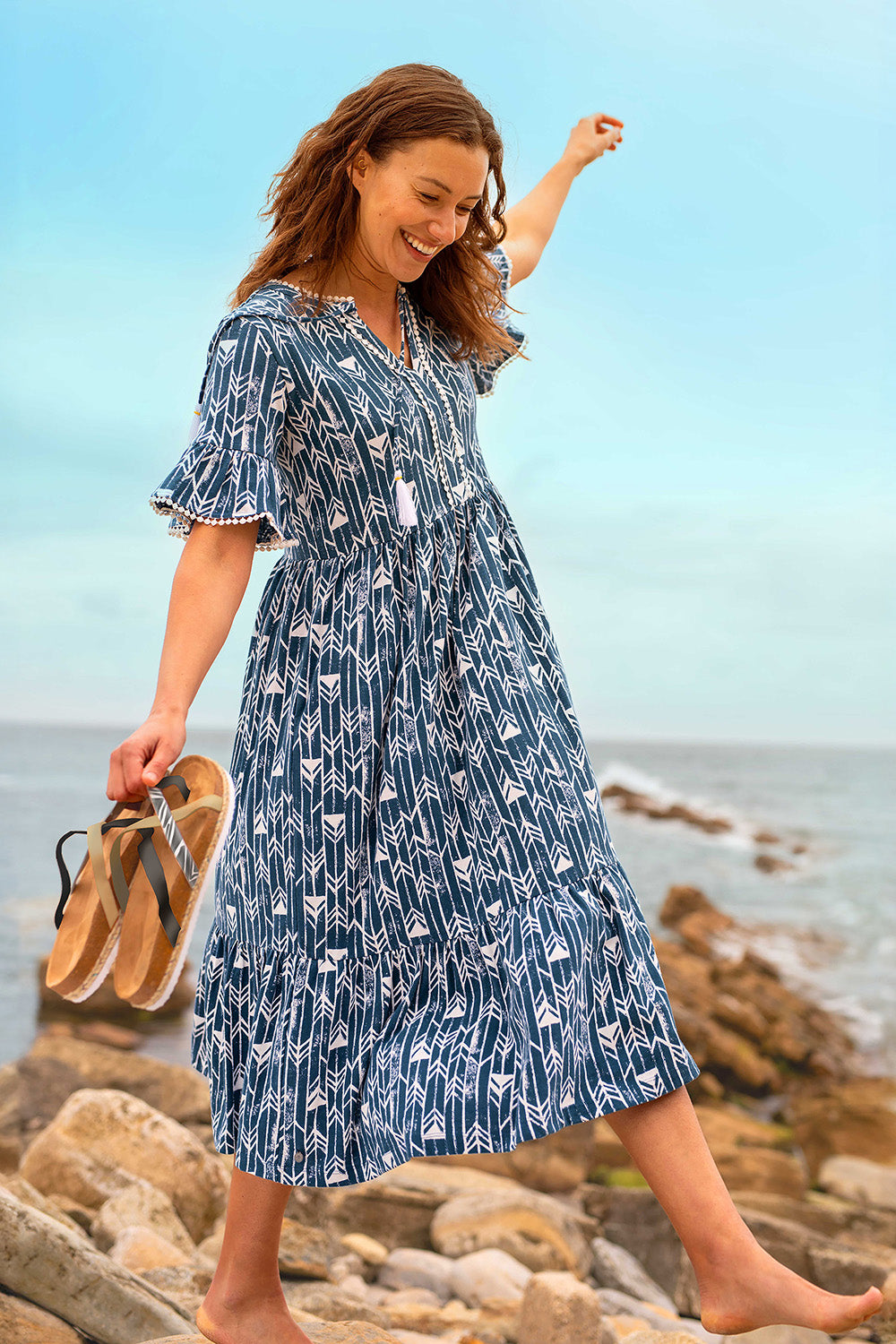 A model wearing the Arrows Cotton Midi Dress in colour Navy (Blue), from the front, showing the whole outfit