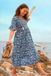 A model wearing the Arrows Cotton Midi Dress in colour Navy (Blue), from the front, showing the whole outfit