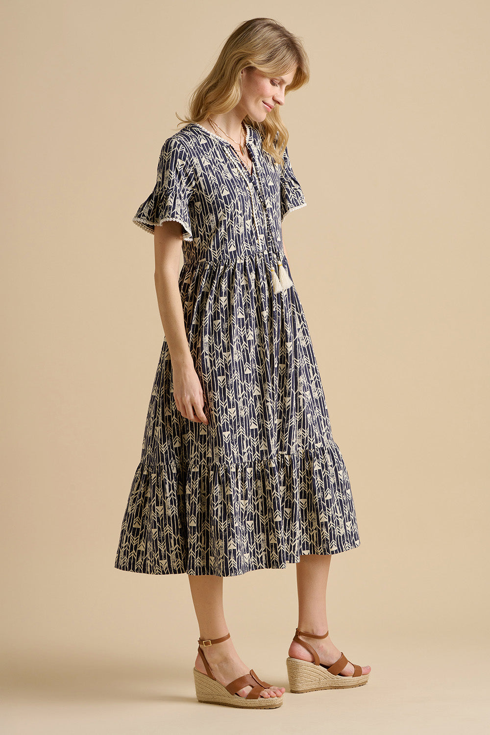 A model wearing the Arrows Cotton Midi Dress in colour Navy (Blue), from the front, showing the whole outfit