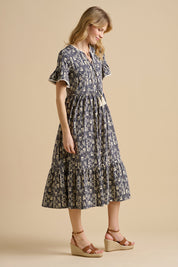A model wearing the Arrows Cotton Midi Dress in colour Navy (Blue), from the front, showing the whole outfit