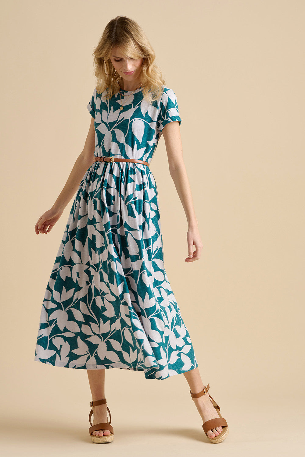 A model wearing the Woodland Leaves Maxi Cotton Jersey Dress in colour Multi (Blue), from the front, showing the whole outfit