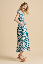 A model wearing the Woodland Leaves Maxi Cotton Jersey Dress in colour Multi (Blue), from the front, showing the whole outfit