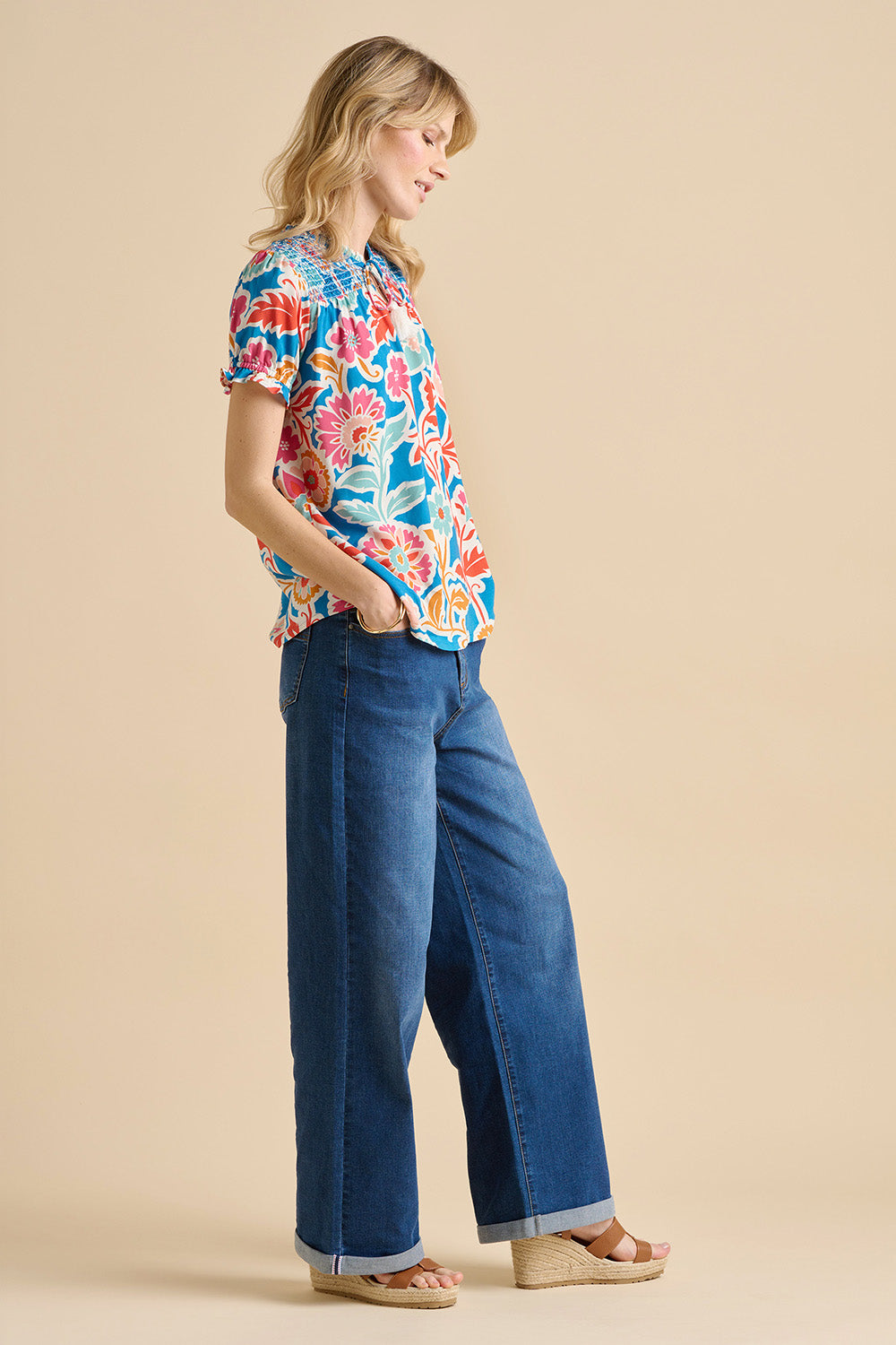 A model wearing the Full Bloom Blouse in colour Multi (Blue), from the front, showing the whole outfit