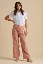 A model wearing the Cowrie Cotton Blouse in colour White (White), from the front, showing the whole outfit