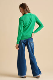 A model wearing the Kelly Green Classic Cotton Cardigan in colour Green (Green), from the back