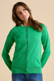 A model wearing the Kelly Green Classic Cotton Cardigan in colour Green (Green), from the front, cropped image