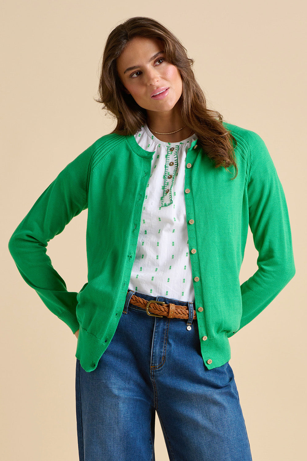 A model wearing the Kelly Green Classic Cotton Cardigan in colour Green (Green), from the front, cropped image