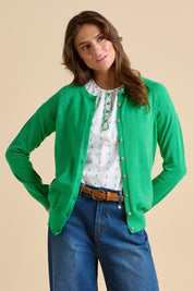A model wearing the Kelly Green Classic Cotton Cardigan in colour Green (Green), from the front, cropped image