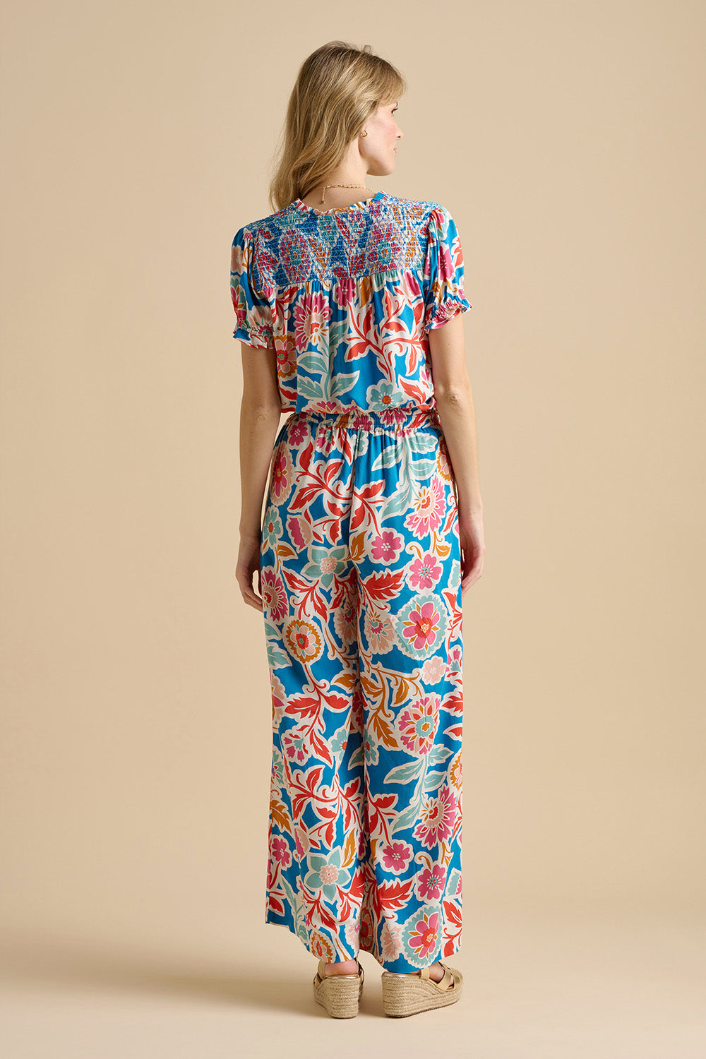 A model wearing the Full Bloom Trouser in colour Multi, from the back