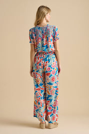 A model wearing the Full Bloom Trouser in colour Multi, from the back