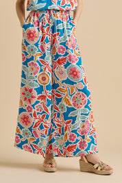 A model wearing the Full Bloom Trouser in colour Multi, from the front, cropped image