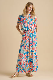 A model wearing the Full Bloom Trouser in colour Multi, from the front, showing the whole outfit