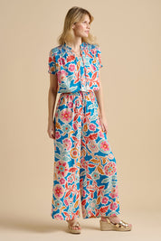 A model wearing the Full Bloom Trouser in colour Multi, from the front, showing the whole outfit