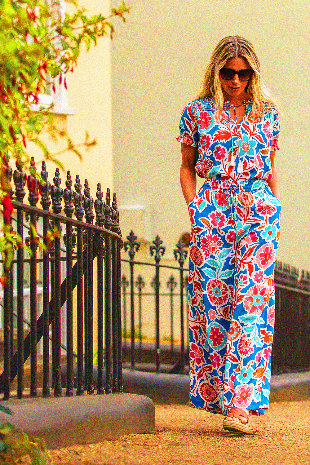 A model wearing the Full Bloom Trouser in colour Multi, from the front, showing the whole outfit
