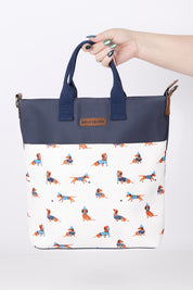 A model wearing size OneSize of the Sausage Dog Tote Bag in colour Creamnavy, from the front, showing the whole outfit