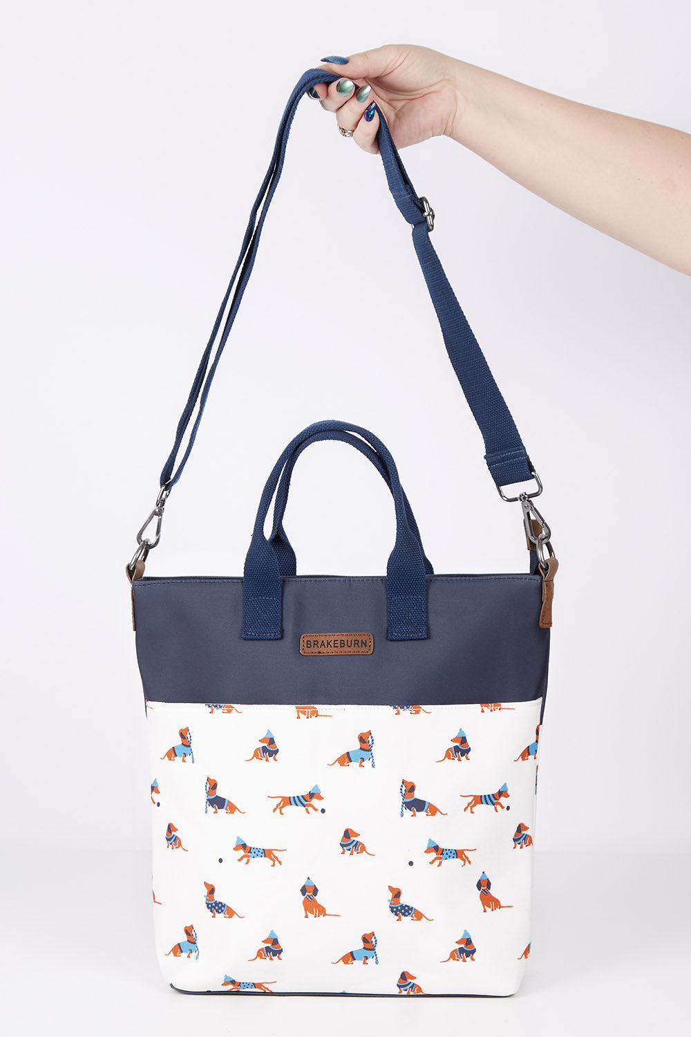 A model wearing size OneSize of the Sausage Dog Tote Bag in colour Creamnavy, from the front, showing the whole outfit