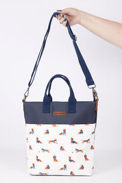 A model wearing size OneSize of the Sausage Dog Tote Bag in colour Creamnavy, from the front, showing the whole outfit