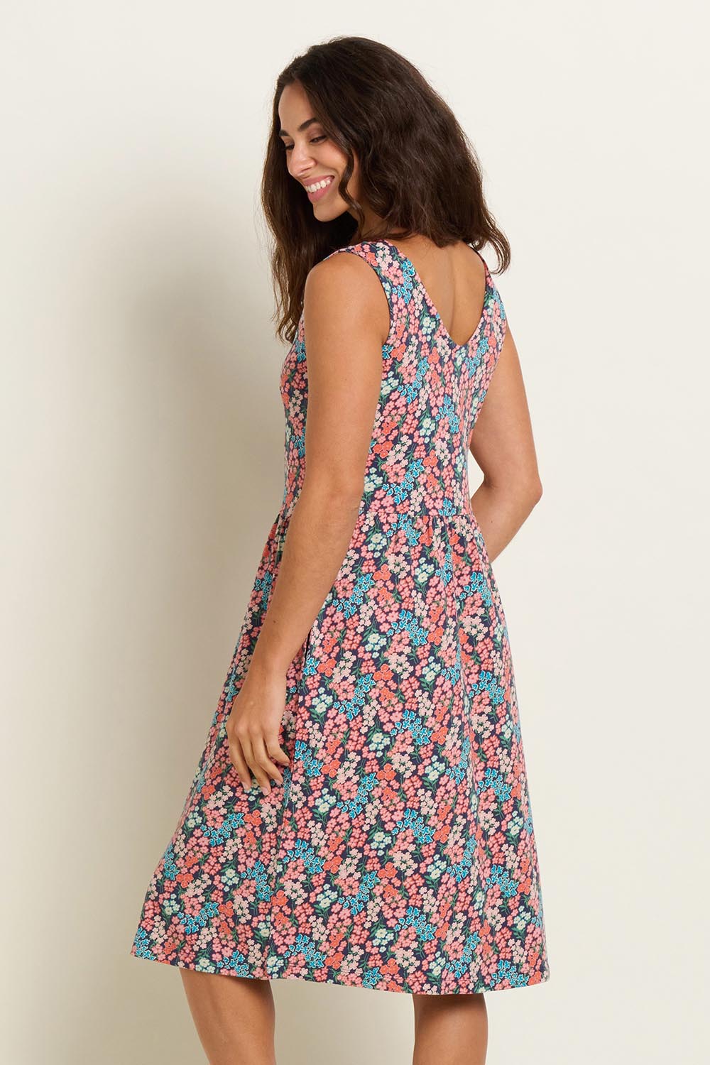 A model wearing the Millie Sleeveless Dress in colour Multi (Blue), from the back
