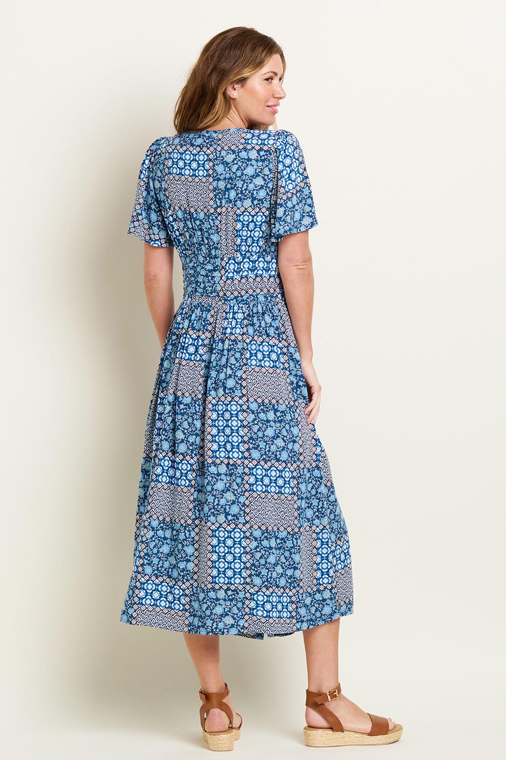 A model wearing the Folk Floral Patchwork Dress in colour Blue (Blue), from the back