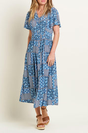 A model wearing the Folk Floral Patchwork Dress in colour Blue (Blue), from the front, cropped image
