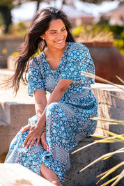 A model wearing the Folk Floral Patchwork Dress in colour Blue (Blue), from the front, showing the whole outfit