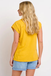 A model wearing the Zoe Tee in colour Yellow, from the back
