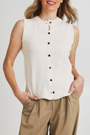 Model Olivia wearing the Knit Vest in colour Beige, from the front, cropped image