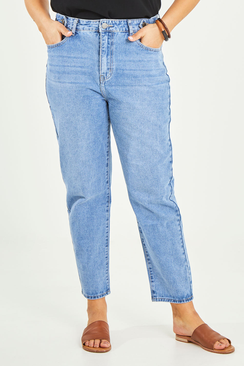 Model Terri-Leigh wearing size 14 of the Kristy Straight Jean in colour Midblue (Blue), from the front, cropped image