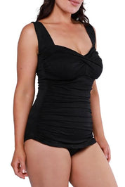 A model wearing the Classique Retro Skirted One Piece in colour Black (Black), from the front, cropped image