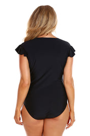 A model wearing the Zip Front One Piece in colour Black (Black), from the back