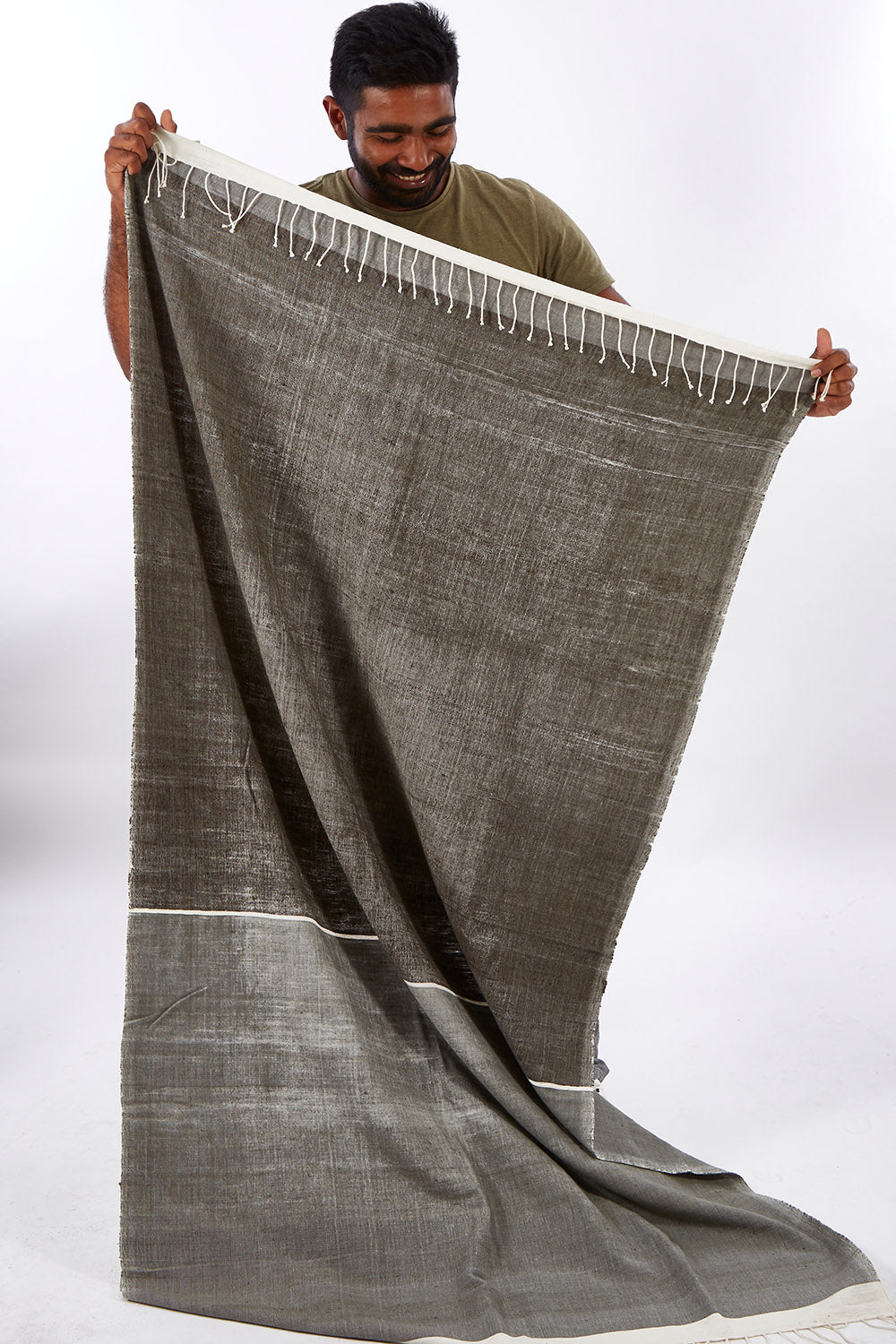 A model wearing size OneSize of the Handwoven Abay Beach Towel in colour Lightgrey (Grey), from the front, showing the whole outfit