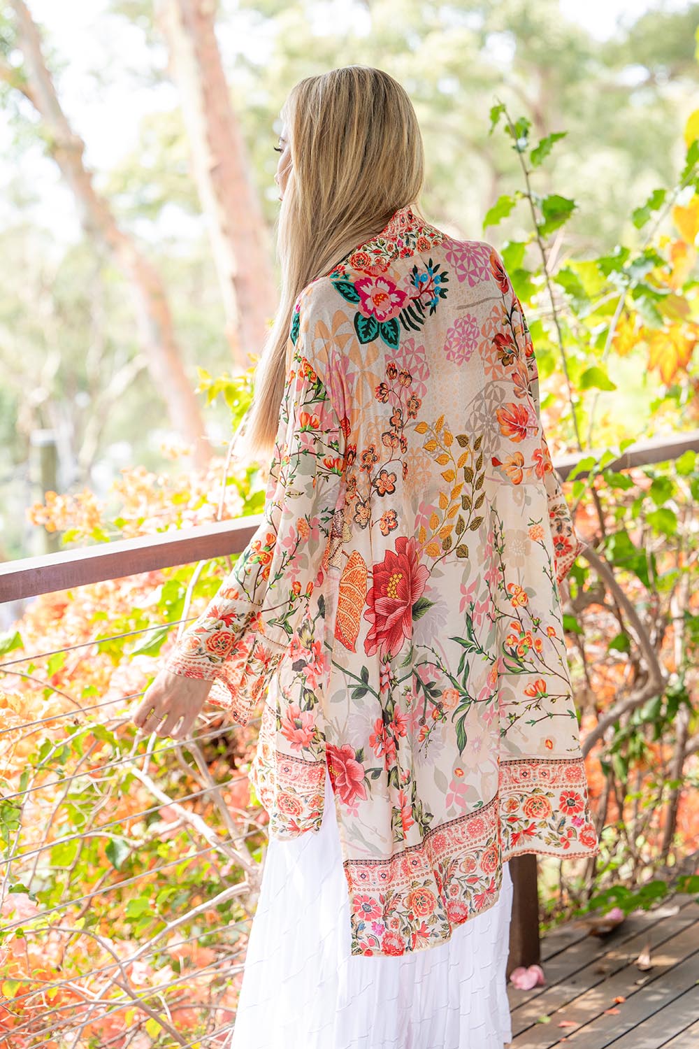A model wearing the Rouge Bloom Kimono in colour Rouge, from the front, showing the whole outfit