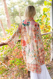 A model wearing the Rouge Bloom Kimono in colour Rouge, from the front, showing the whole outfit