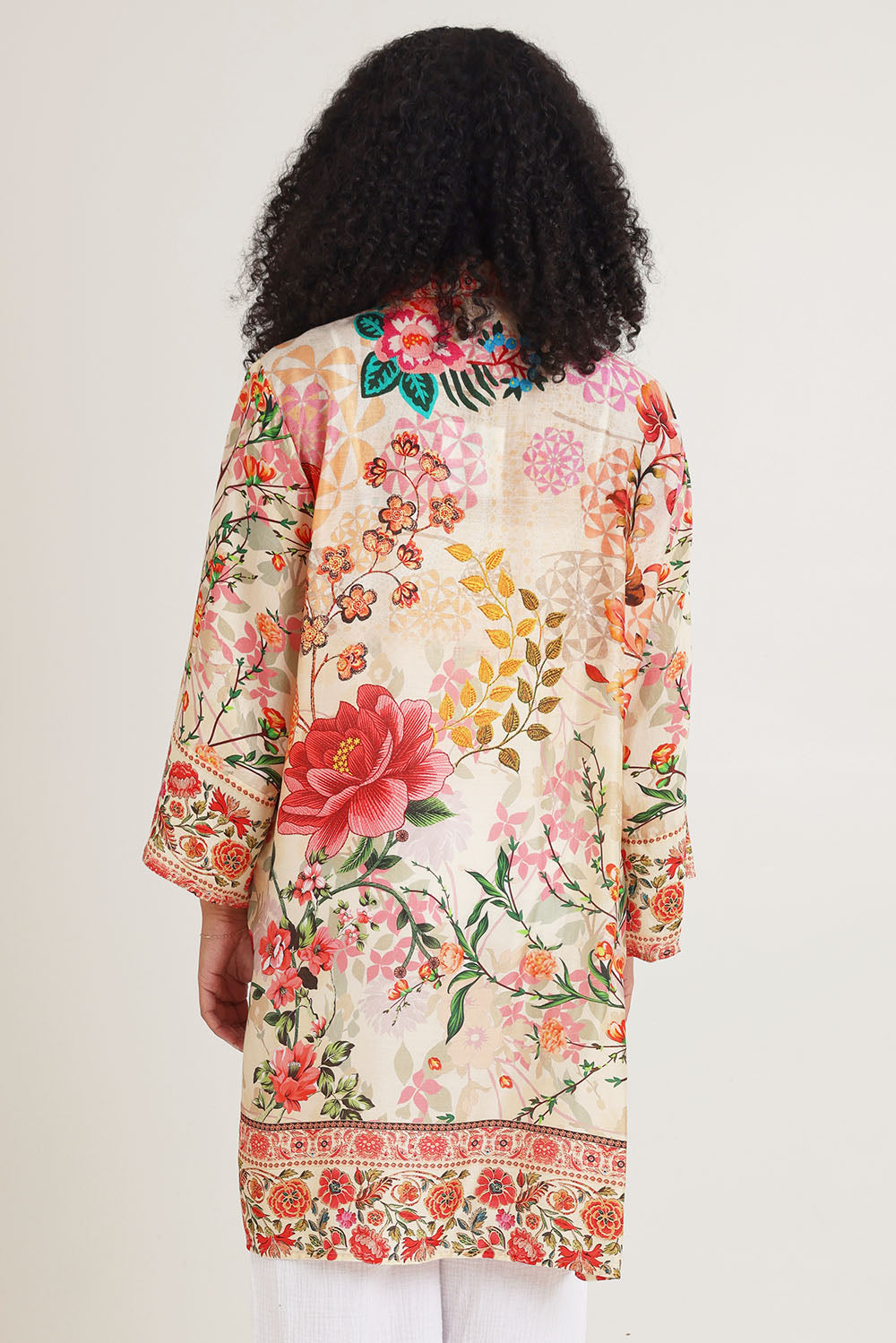 Model Ziara wearing the Rouge Bloom Kimono in colour Rouge, from the back
