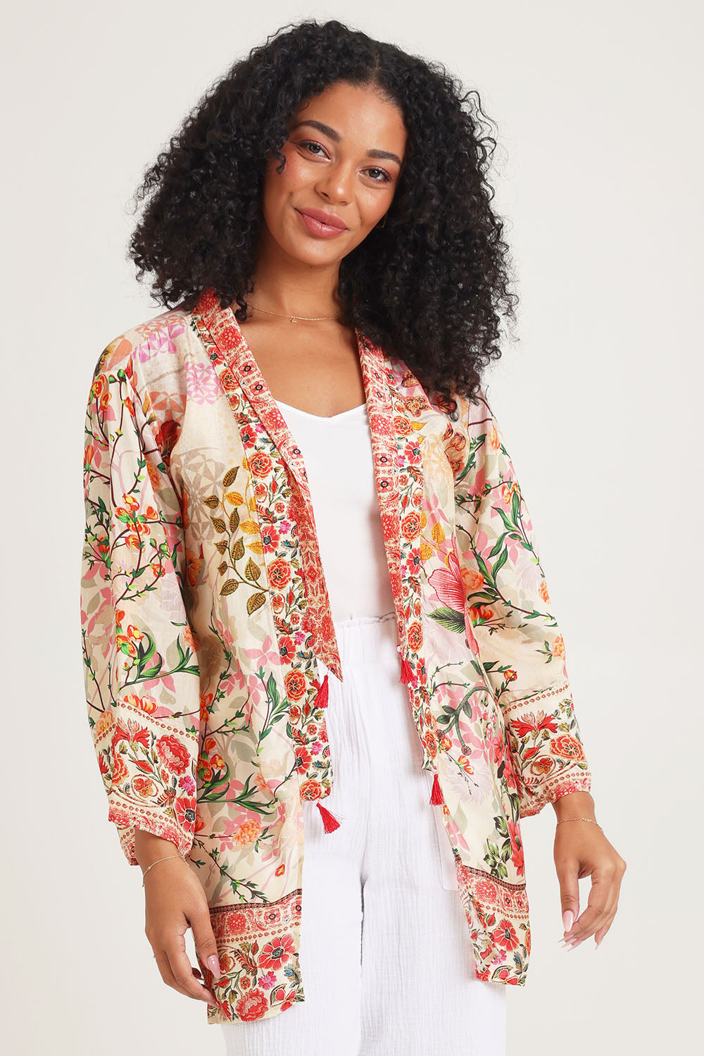 Model Ziara wearing the Rouge Bloom Kimono in colour Rouge, from the front, cropped image