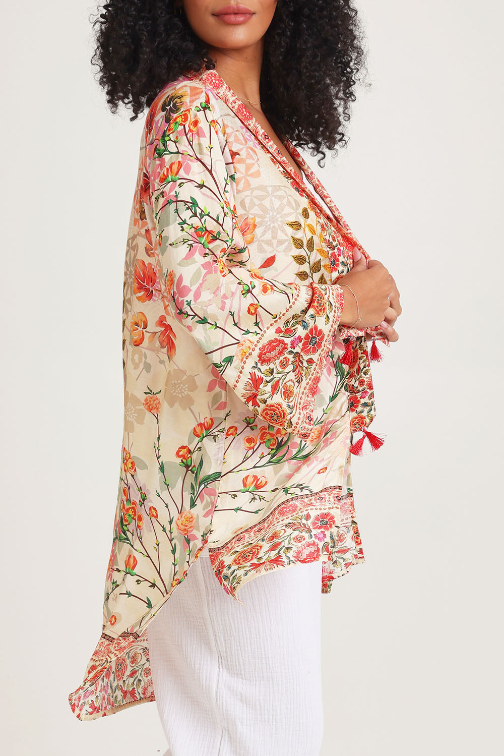 Model Ziara wearing the Rouge Bloom Kimono in colour Rouge, from the front, cropped image