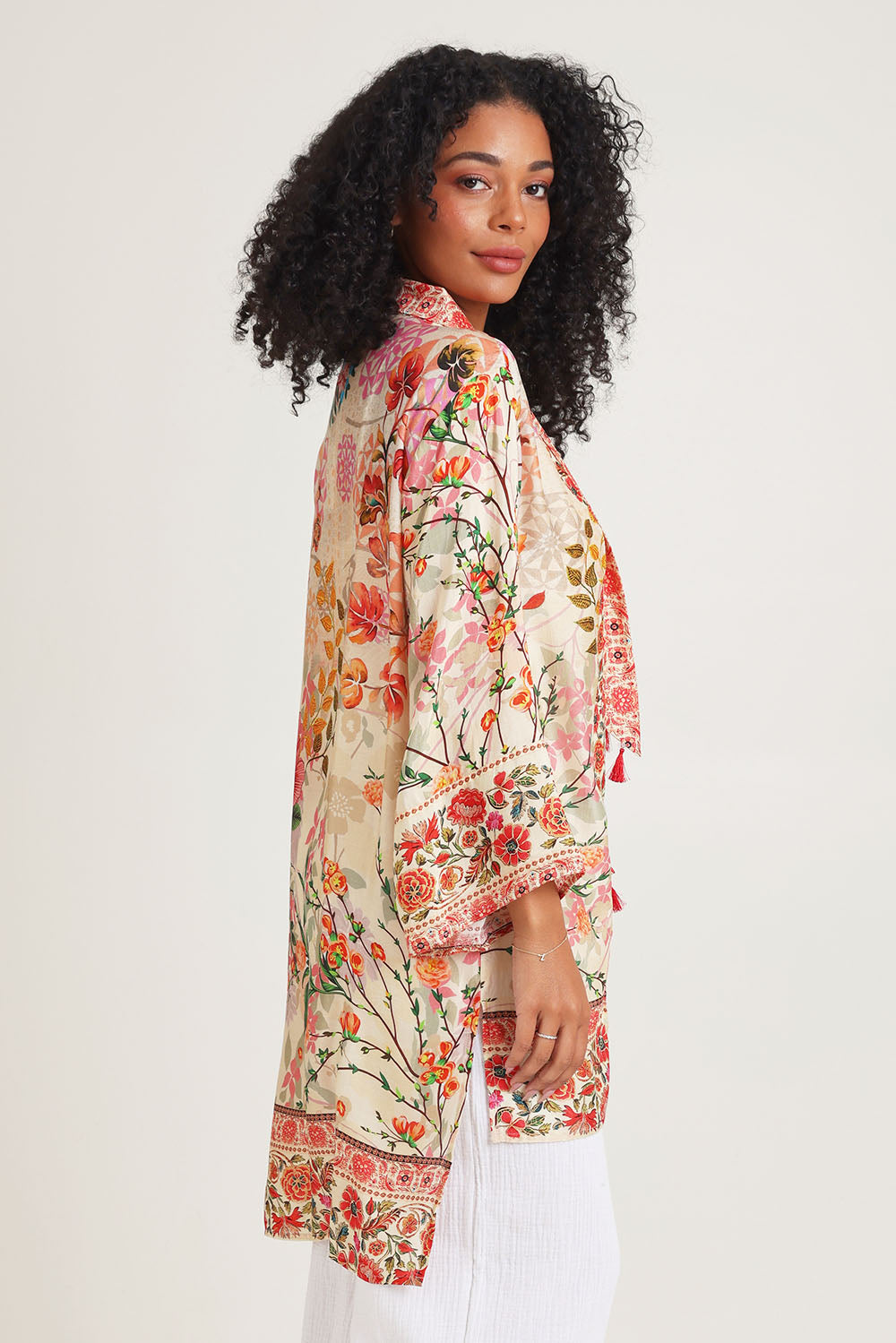 Model Ziara wearing the Rouge Bloom Kimono in colour Rouge, from the front, cropped image