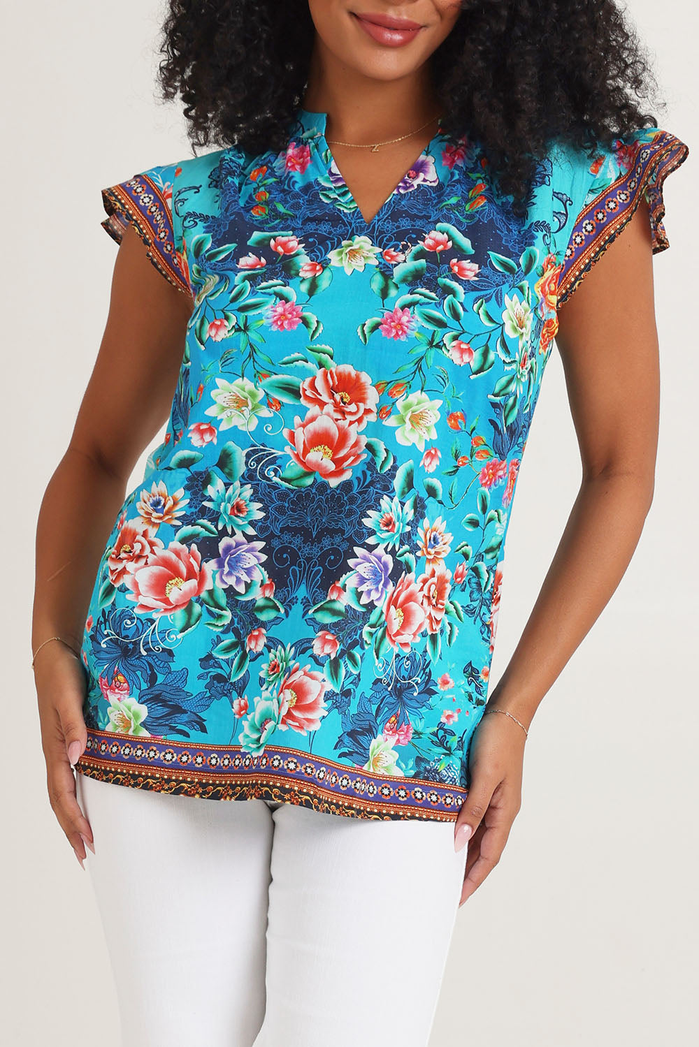 Model Ziara wearing size S of the Lotus Garden Sarah Cotton Top in colour Lotus (Blue), from the front, cropped image