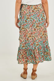 Model Georgia wearing size OneSize of the Eden Wrap Skirt in colour Eden (Blue), from the back