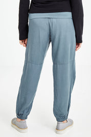 Model Elise wearing size S of the Lyocell Pant in colour Slate (Grey), from the back