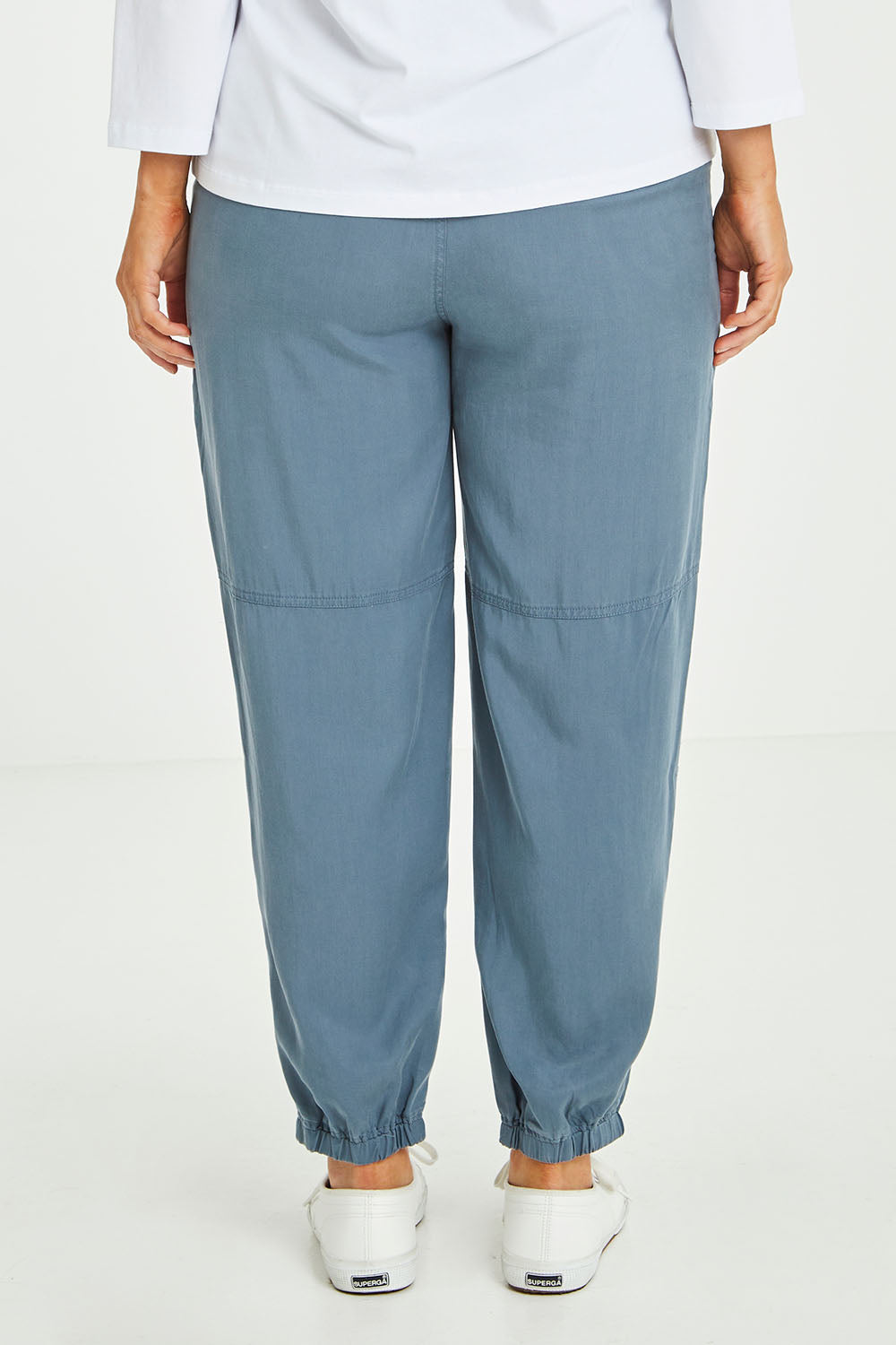 Model Laura wearing size L of the Lyocell Pant in colour Slate (Grey), from the back