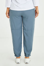 Model Laura wearing size L of the Lyocell Pant in colour Slate (Grey), from the back